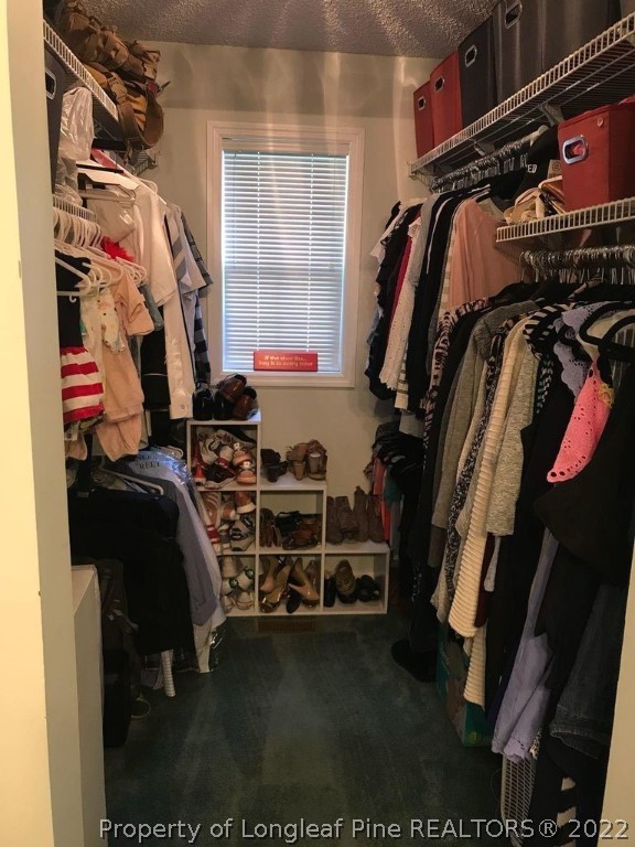 21 Princess Gate Whispering Pines, NC 28327 - Photo 24 of 33 a view of walk in closet with clothes and shoes