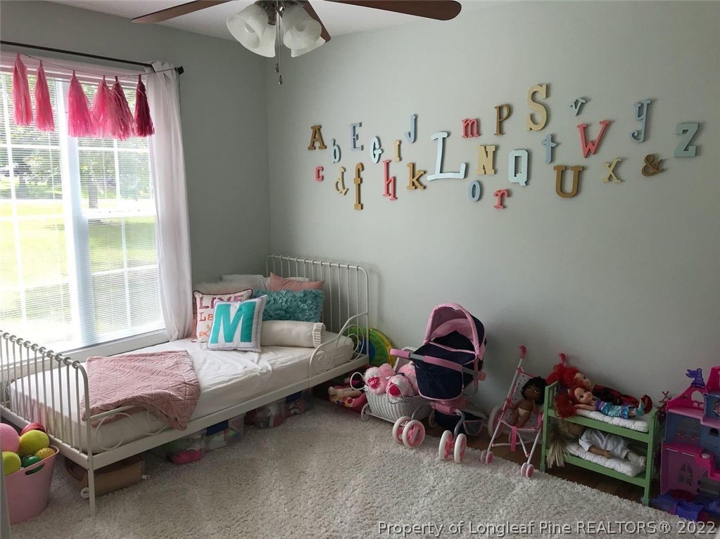 21 Princess Gate Whispering Pines, NC 28327 - Photo 32 of 33 a bedroom with a bed and a window
