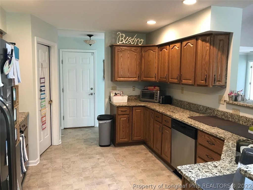21 Princess Gate Whispering Pines, NC 28327 - Photo 10 of 33 a kitchen with stainless steel appliances granite countertop a refrigerator and a sink