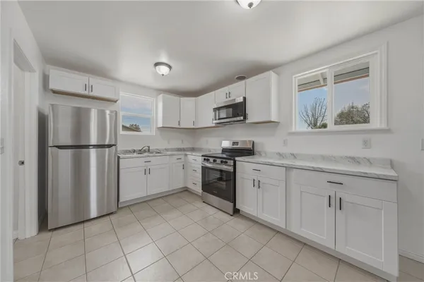 an empty room with a white walls and ceiling fan