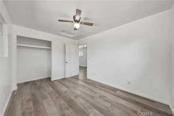 a view of a house with a yard and a large tree