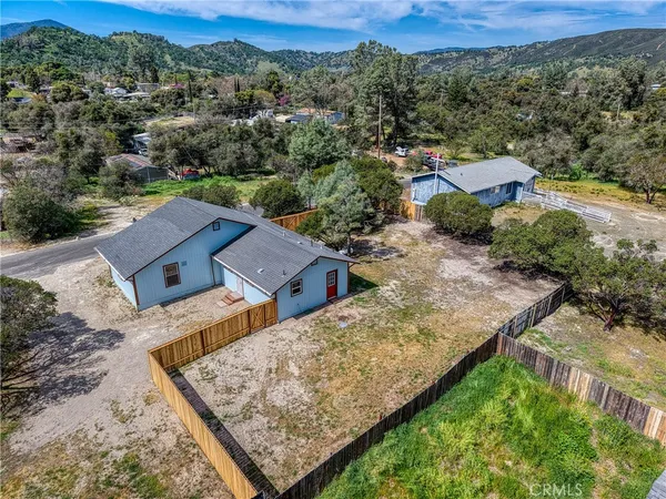 an aerial view of a house with a yard and lake view