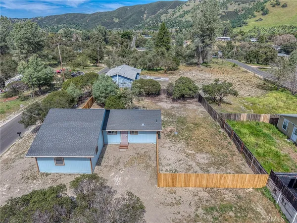 an aerial view of residential houses with outdoor space and street view