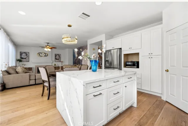 a kitchen with a white cabinets and chairs