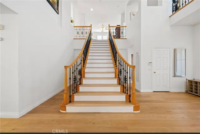 a view of entryway and hall with wooden floor