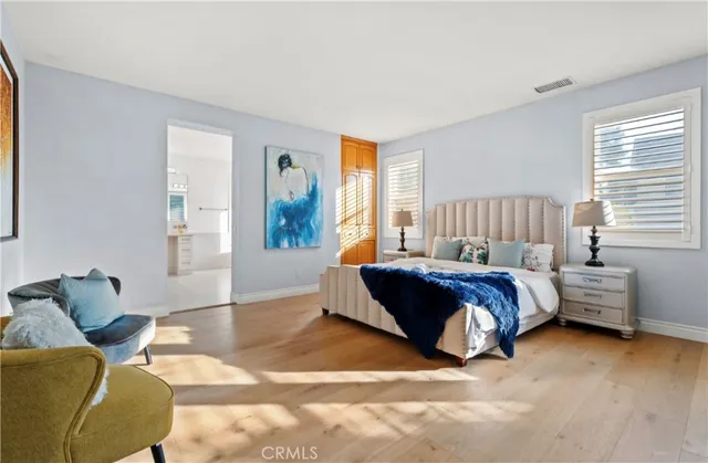 a spacious bedroom with a bed and window