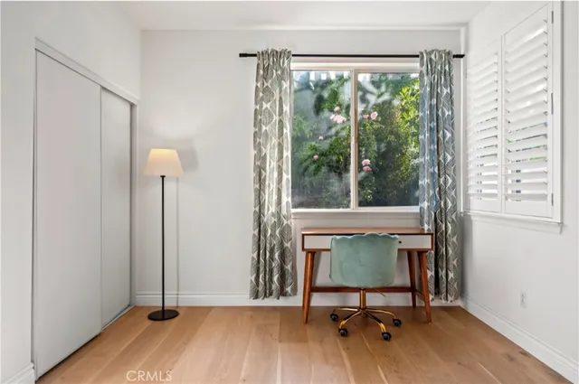 a view of a livingroom with furniture and a window