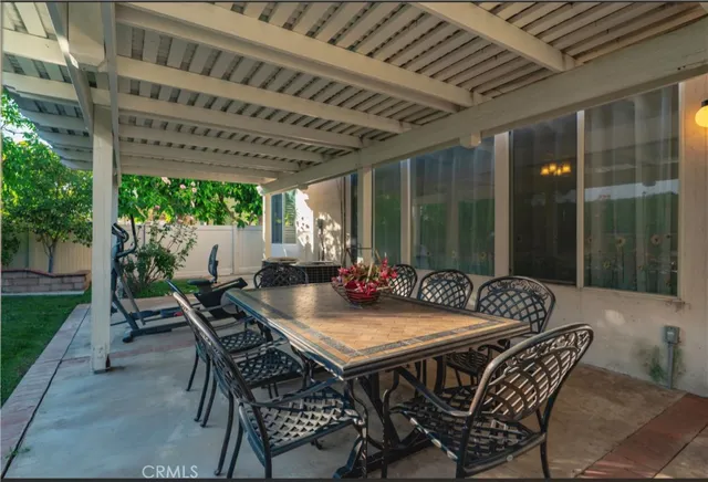a view of an outside dining space with furniture and yard
