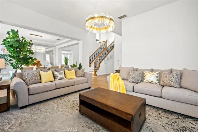a living room with furniture and a chandelier