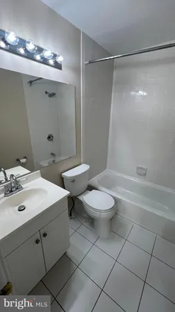 a bathroom with a toilet a sink a mirror and shower
