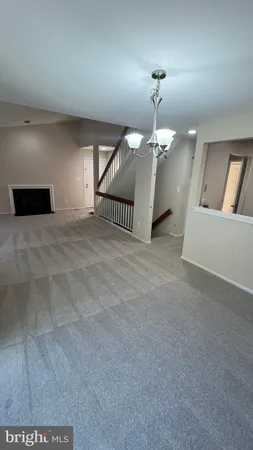 a view of a livingroom with a chandelier fan