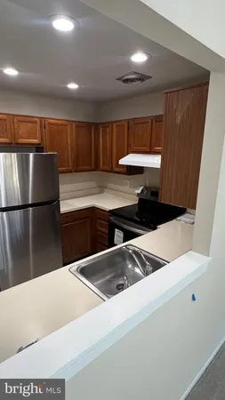 a kitchen with a refrigerator and a sink