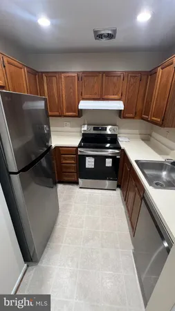 a kitchen with stainless steel appliances granite countertop a stove and a sink