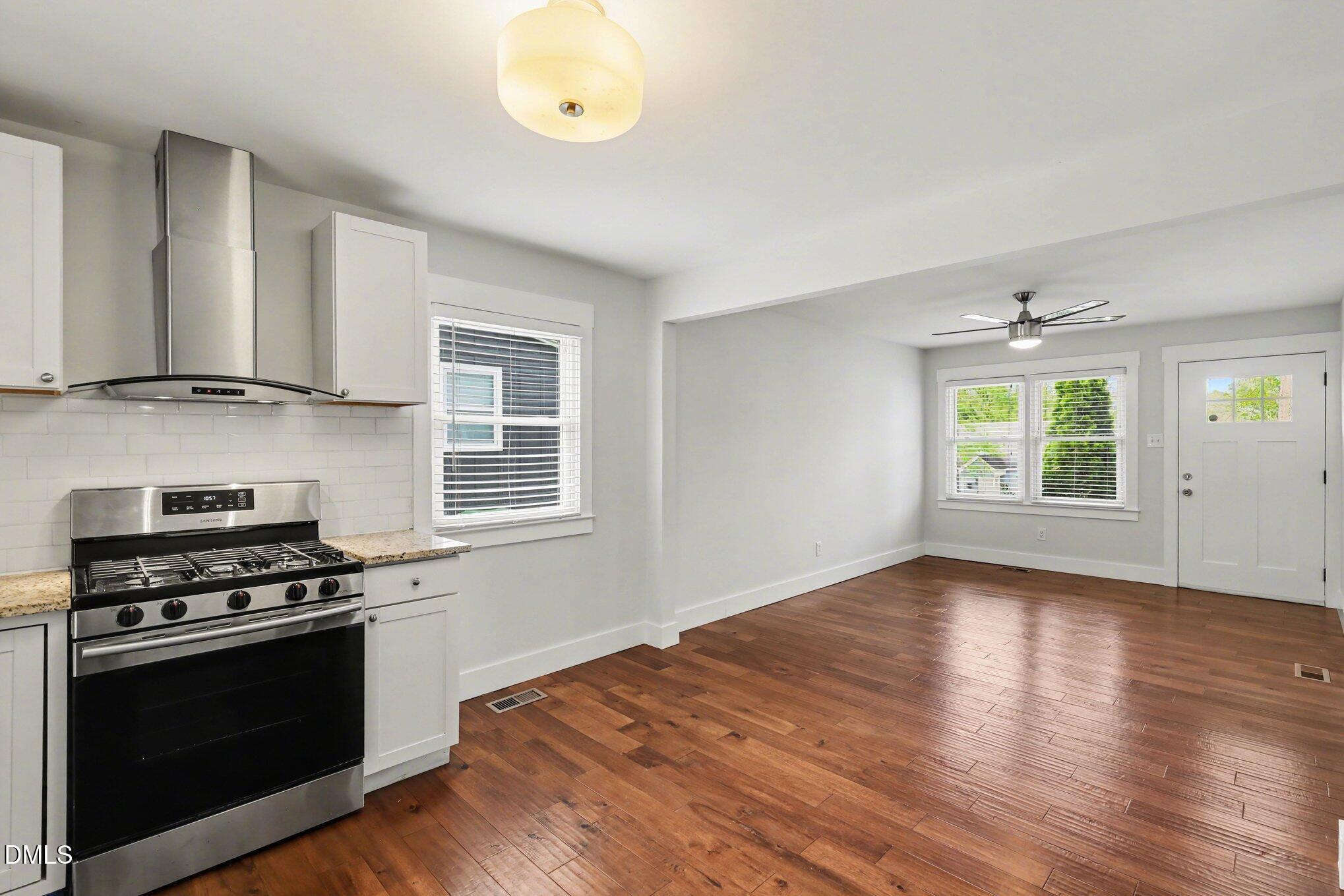 727 South State Street Raleigh, NC 27601 - Photo 9 of 30 a kitchen with granite countertop wooden floors and a stove