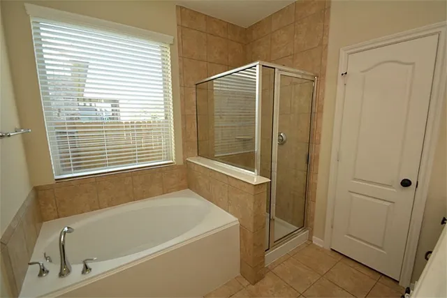a bathroom with a bathtub and a shower