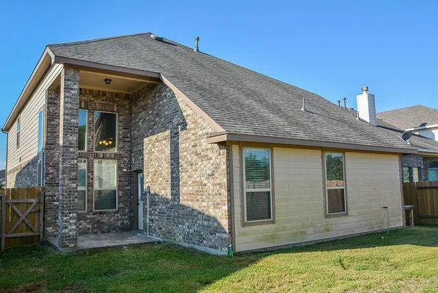 a view of a house with brick walls