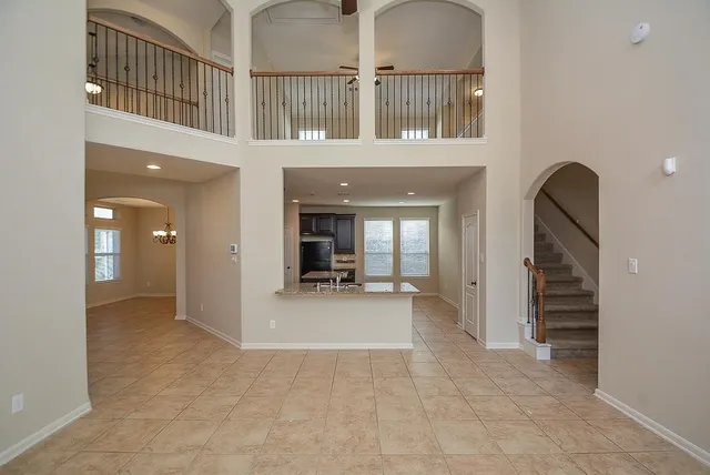 a view of a hallway with entryway and hall with a window