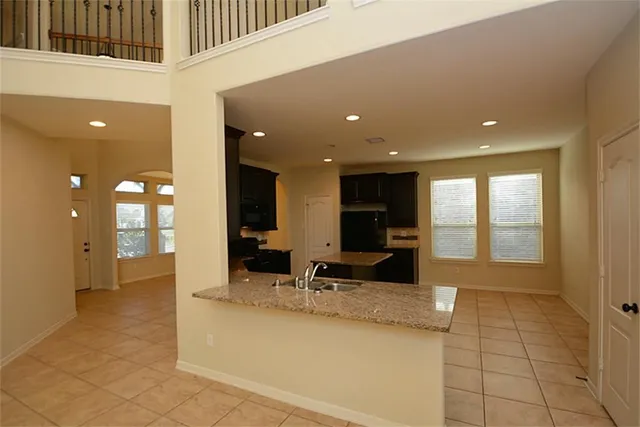 a lobby with furniture and large windows