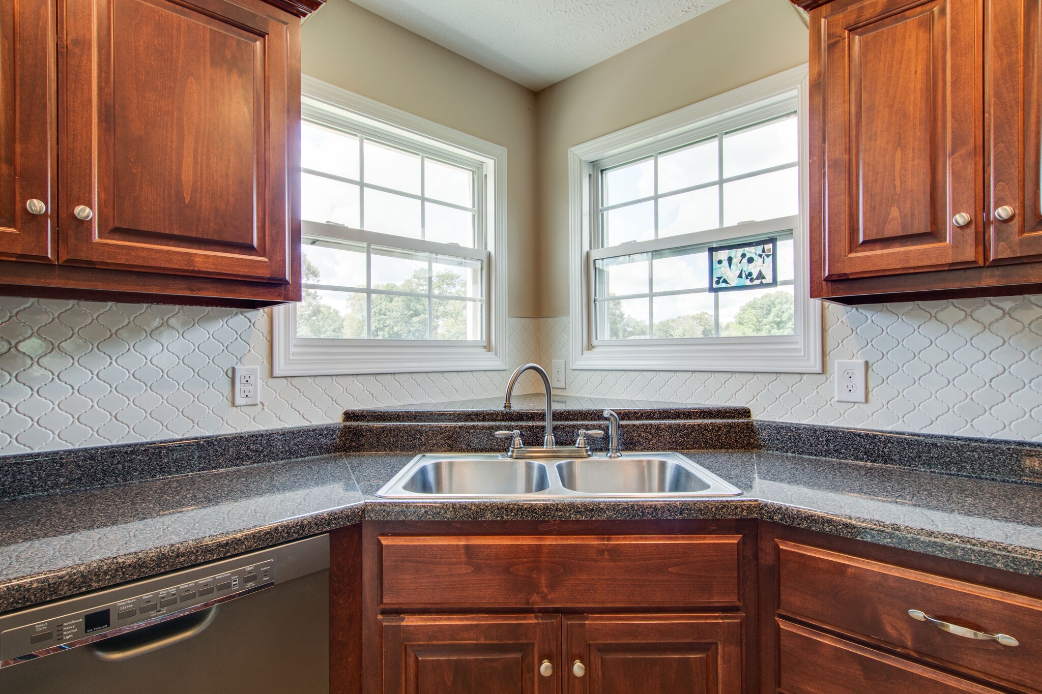 84 Houston Bell Road Manchester, TN 37355 - Photo 12 of 36 a kitchen with stainless steel appliances granite countertop a sink a window and cabinets
