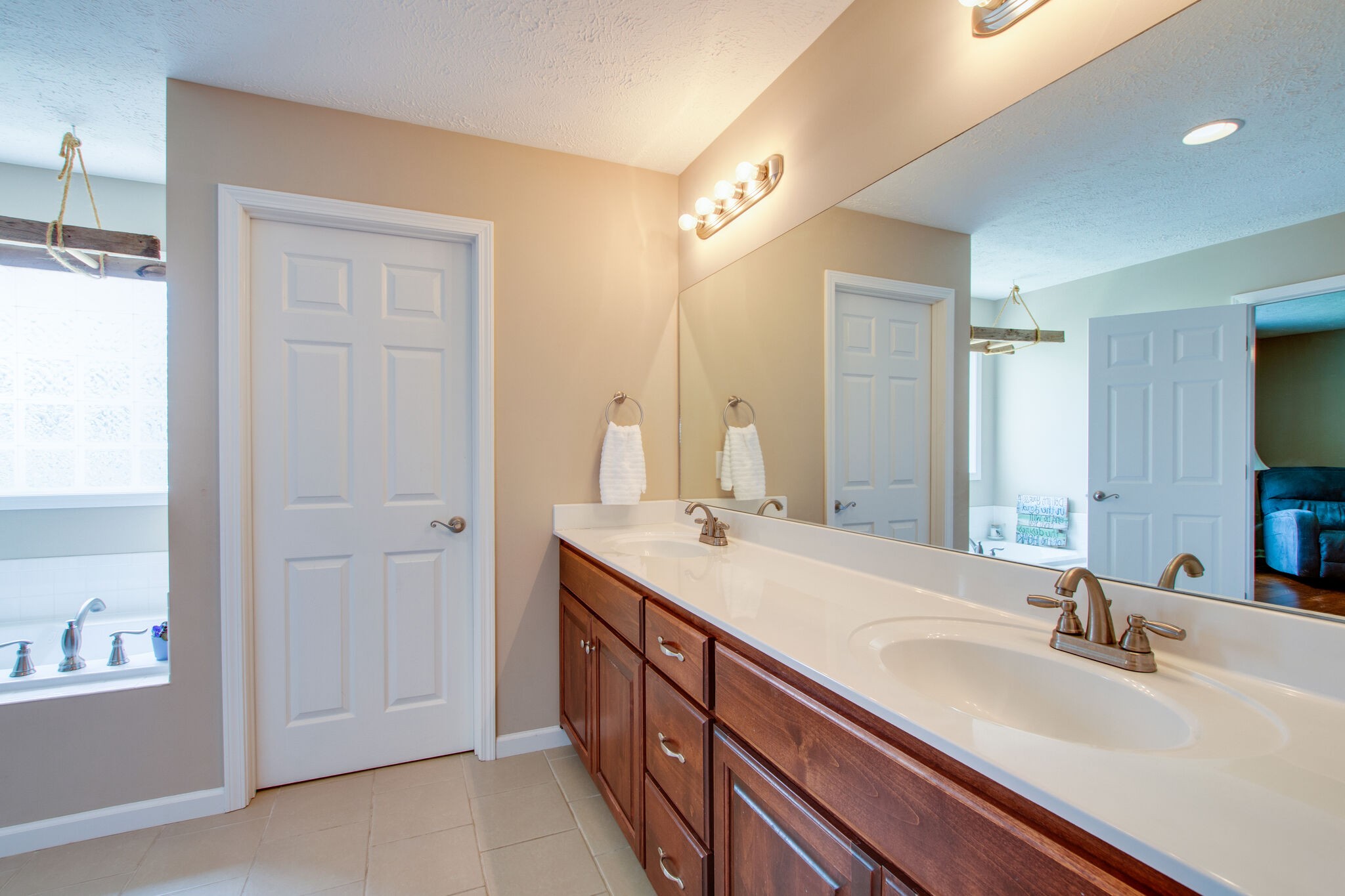 84 Houston Bell Road Manchester, TN 37355 - Photo 16 of 36 a bathroom with double vanity sinks and a mirror