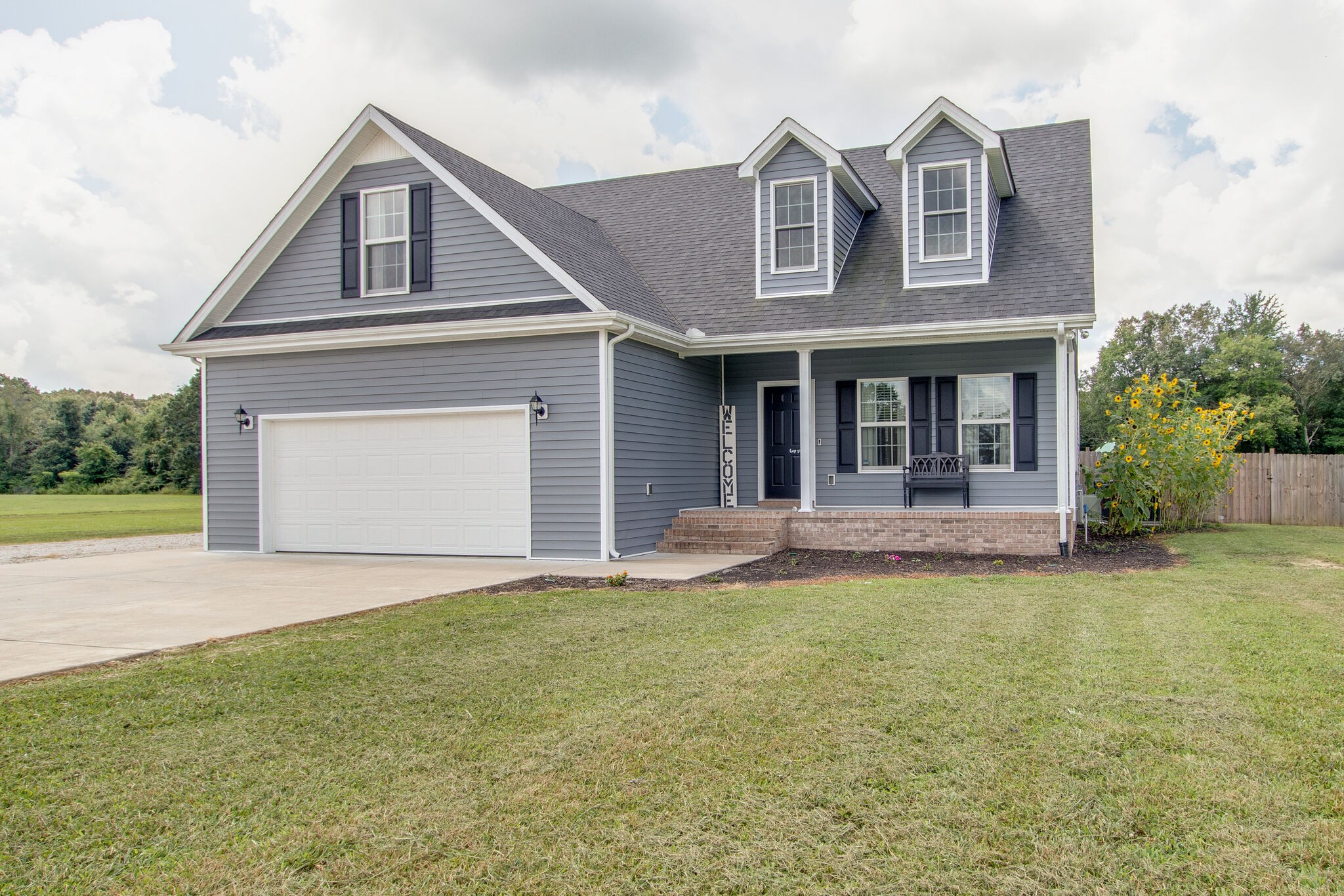 84 Houston Bell Road Manchester, TN 37355 - Photo 3 of 36 a front view of a house with a yard and garage