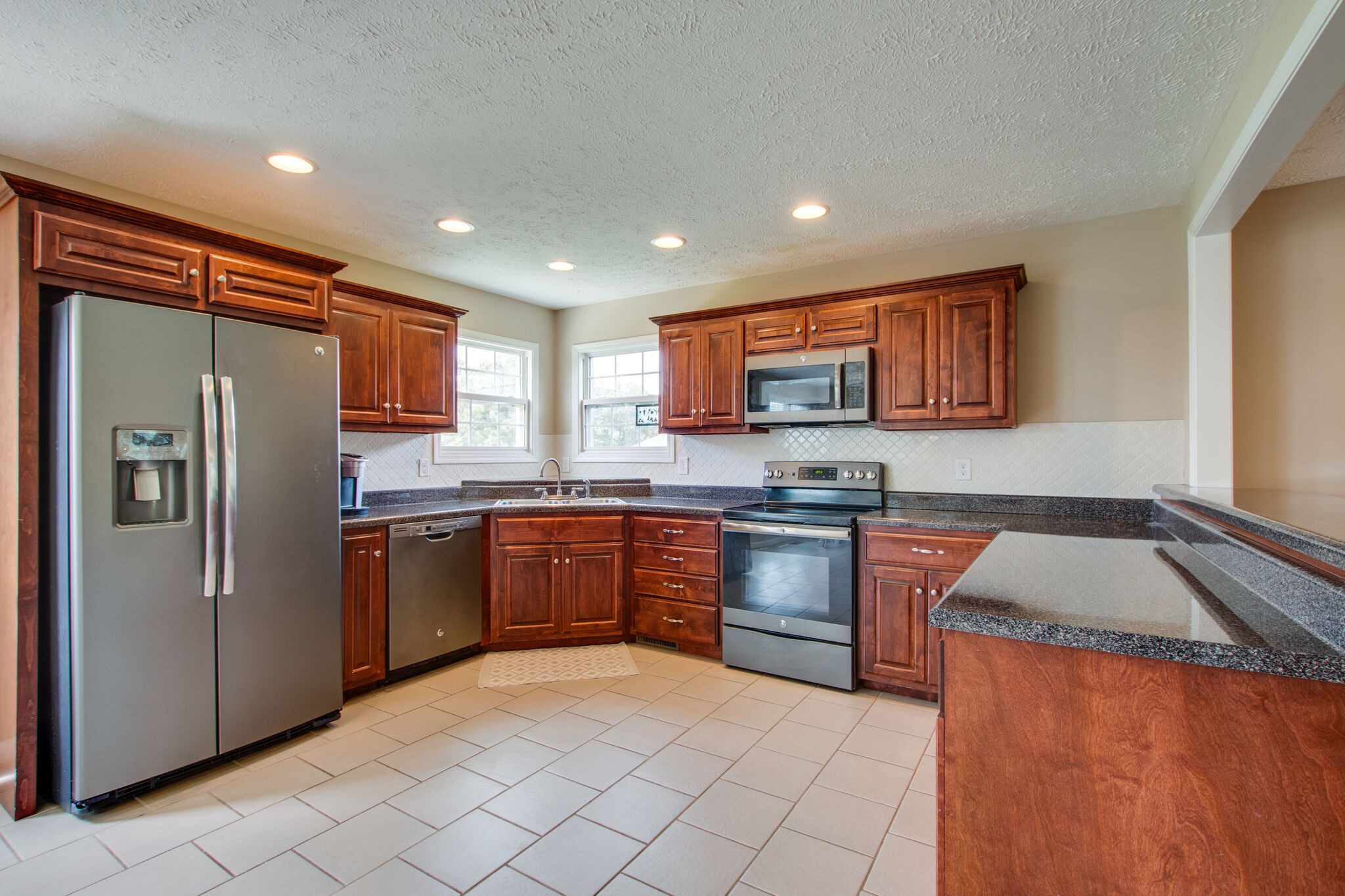 84 Houston Bell Road Manchester, TN 37355 - Photo 10 of 36 a kitchen with stainless steel appliances granite countertop a refrigerator sink and stove