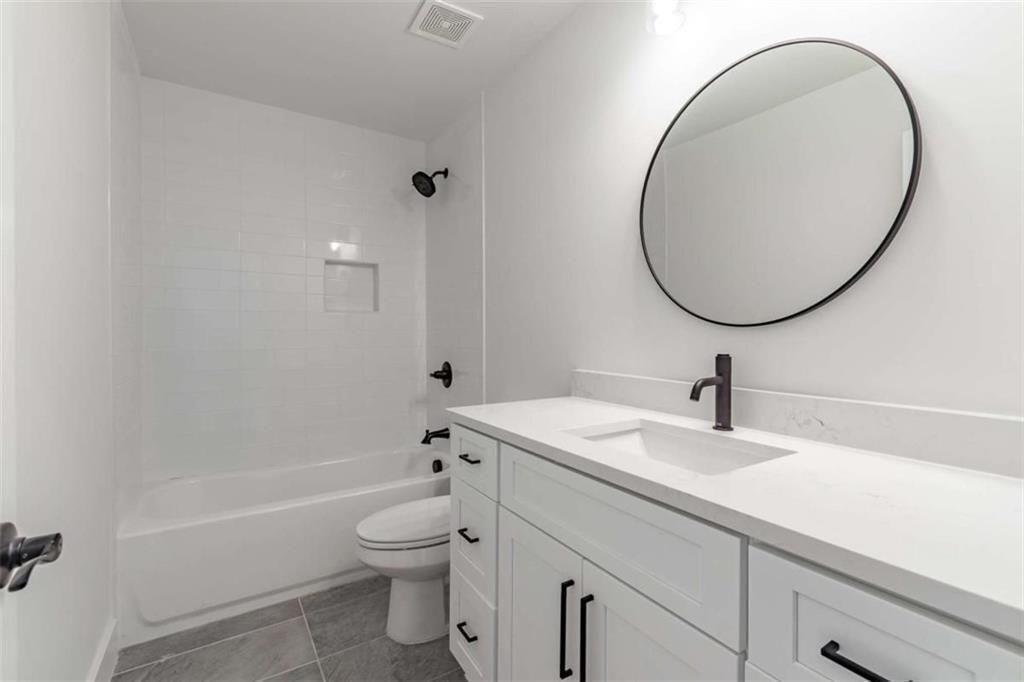 5808 Swinging Gate Road Gainesville, GA 30506 - Photo 37 of 59 a bathroom with a sink a toilet and a mirror
