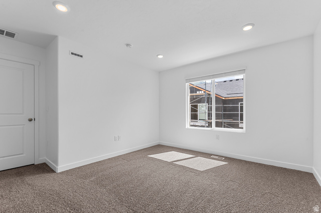 1907 East 640th North, Unit 1225 Salem, UT 84653 - Photo 4 of 20 Spacious room featuring neutral carpeting, white walls, and a large window with white trim
