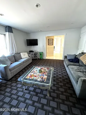 a bedroom with furniture and a rug