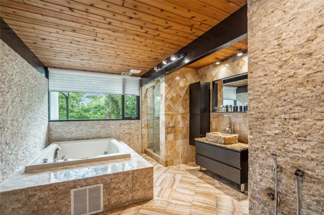 a bedroom with a bed a couch and dresser