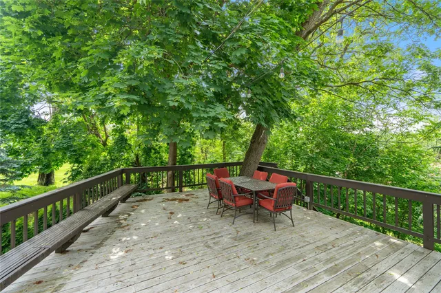 an aerial view of residential house with outdoor space and trees all around