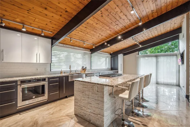 a view of a kitchen with furniture and wooden floor