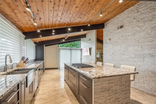 a dining room with stainless steel appliances granite countertop furniture and a fireplace