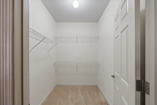 a spacious bathroom with a granite countertop sink a mirror and a shower