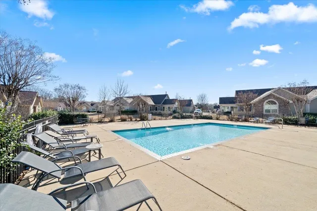a view of a swimming pool and lounge chairs
