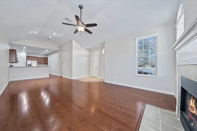 a view of an empty room with a fireplace and a window