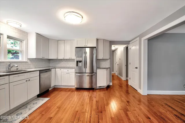 a kitchen with a refrigerator and a stove top oven