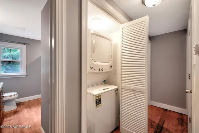 a bathroom with a sink a toilet and a window