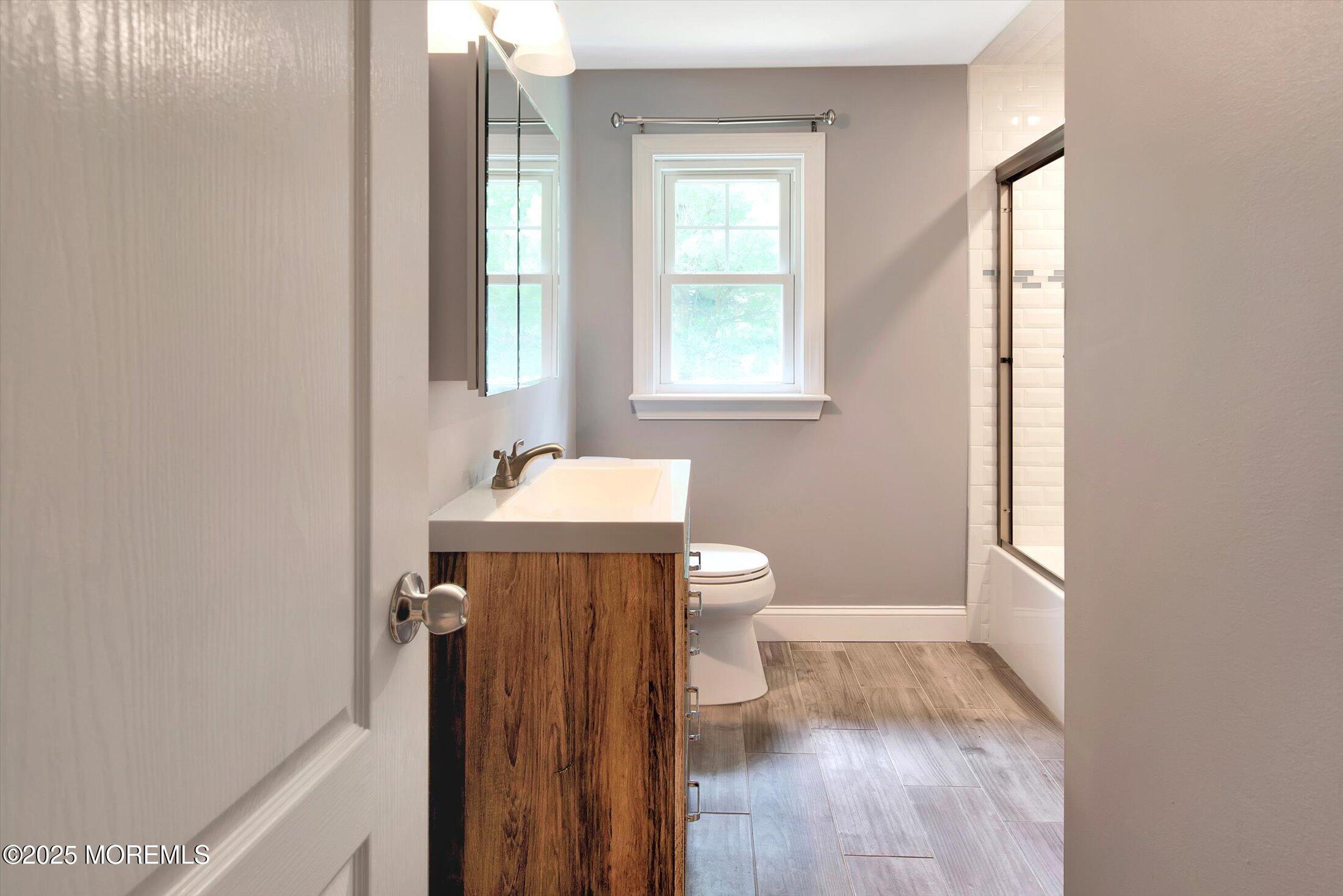 88 Dutch Lane Road Marlboro, NJ 07746 - Photo 25 of 35 a bathroom with a sink a toilet and a window