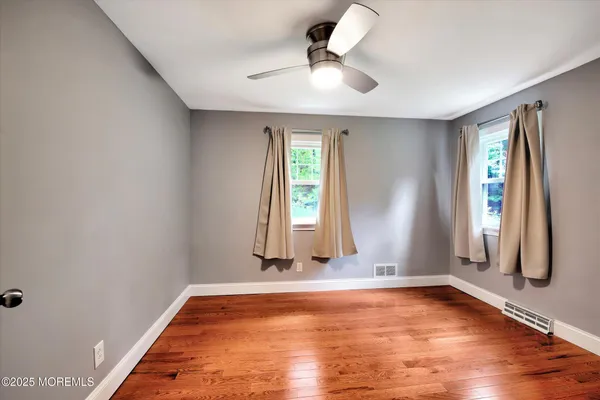 a bathroom with a sink a toilet and a window