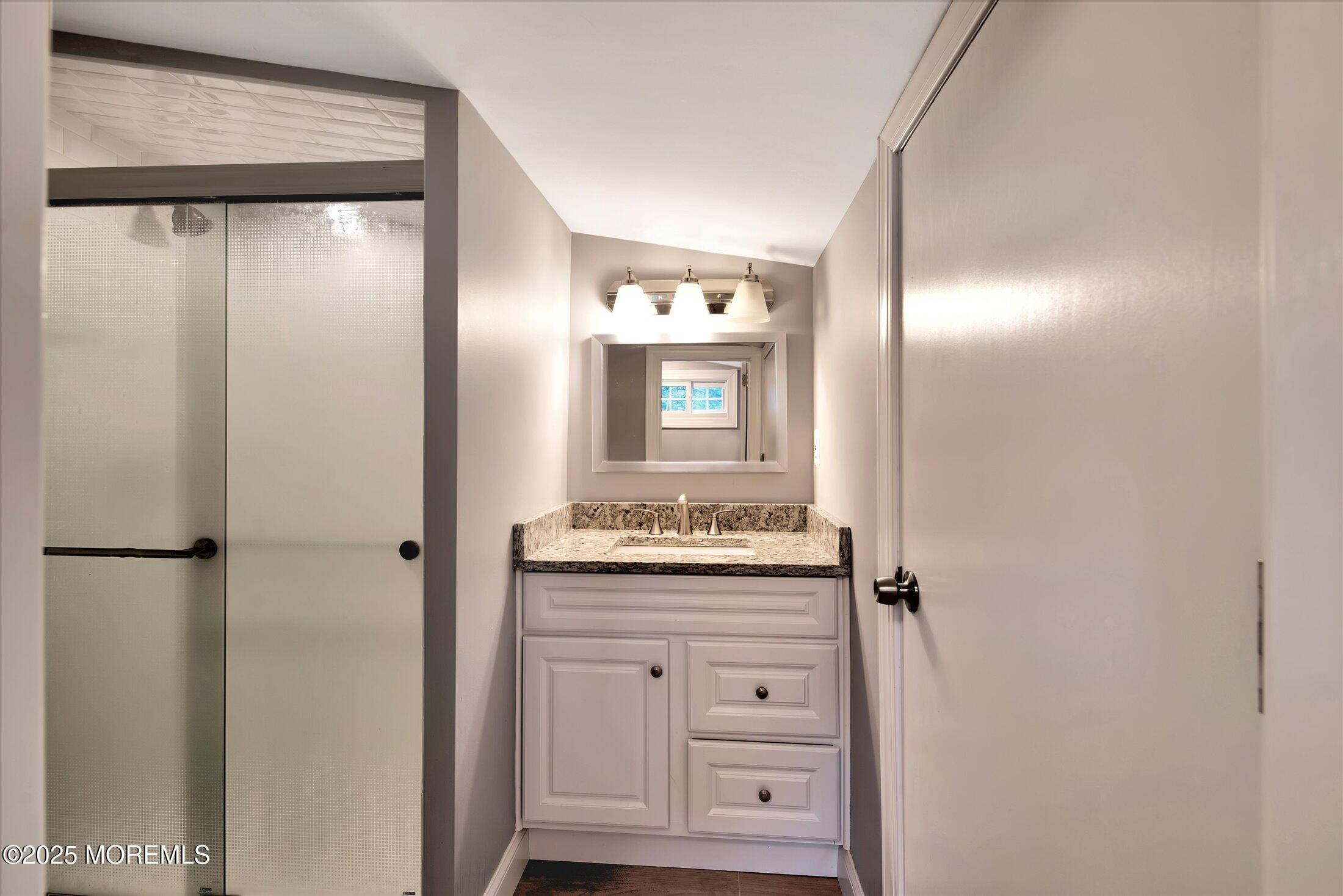 88 Dutch Lane Road Marlboro, NJ 07746 - Photo 31 of 35 a bathroom with a granite countertop sink and a mirror