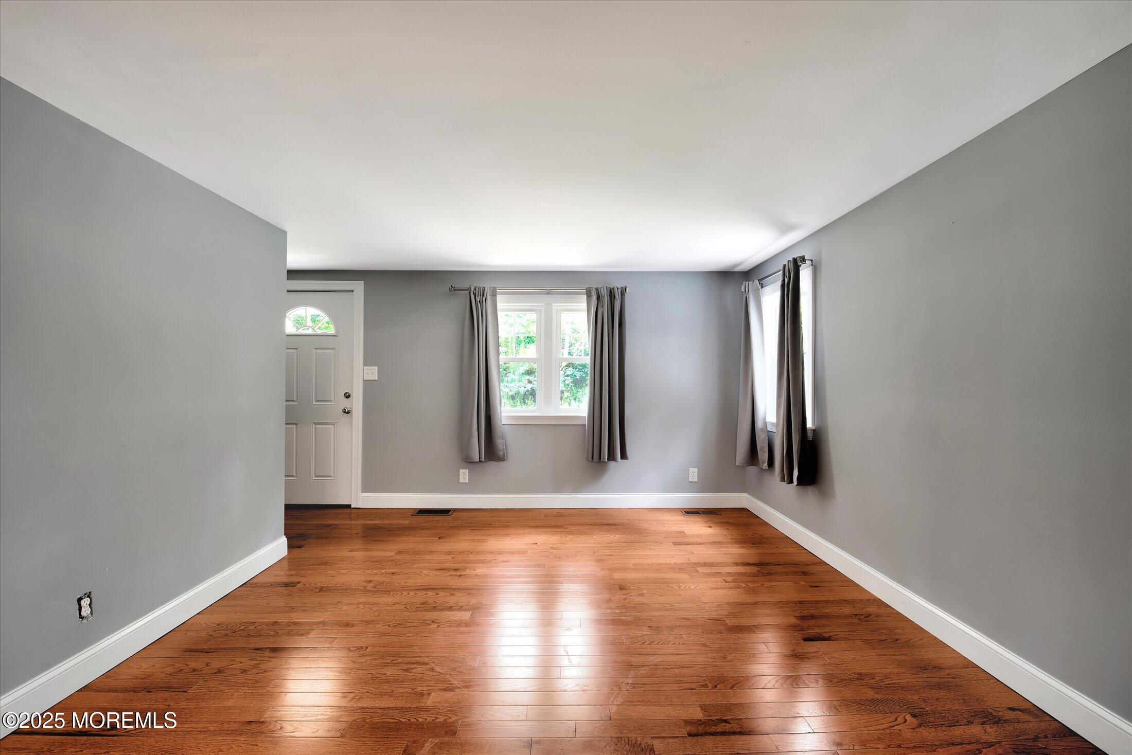 88 Dutch Lane Road Marlboro, NJ 07746 - Photo 10 of 35 a view of an empty room with wooden floor and a window