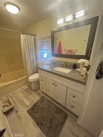 a bathroom with a sink a toilet and mirror
