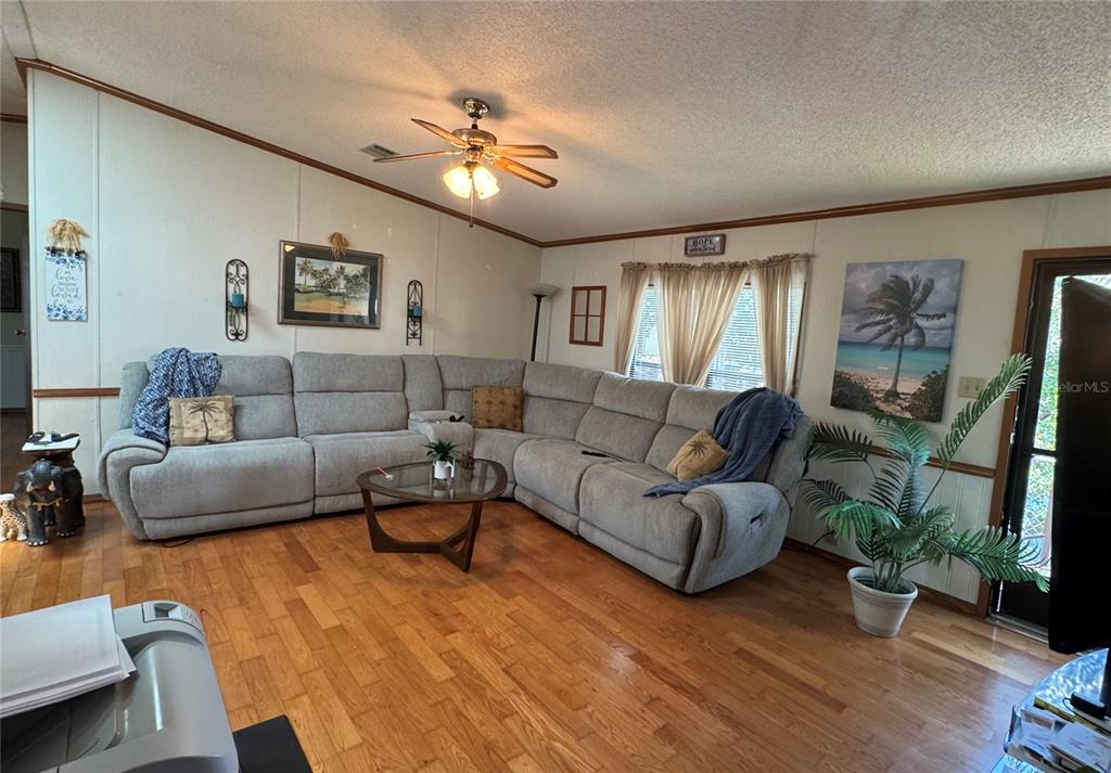 605 Michigan Boulevard, Unit 100 Dunedin, FL 34698 - Photo 8 of 20 a living room with furniture and a wooden floor