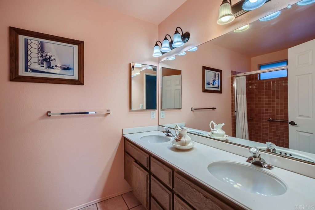 404 Compass Road Oceanside, CA 92054 - Photo 14 of 26 a bathroom with a double vanity sink and a mirror