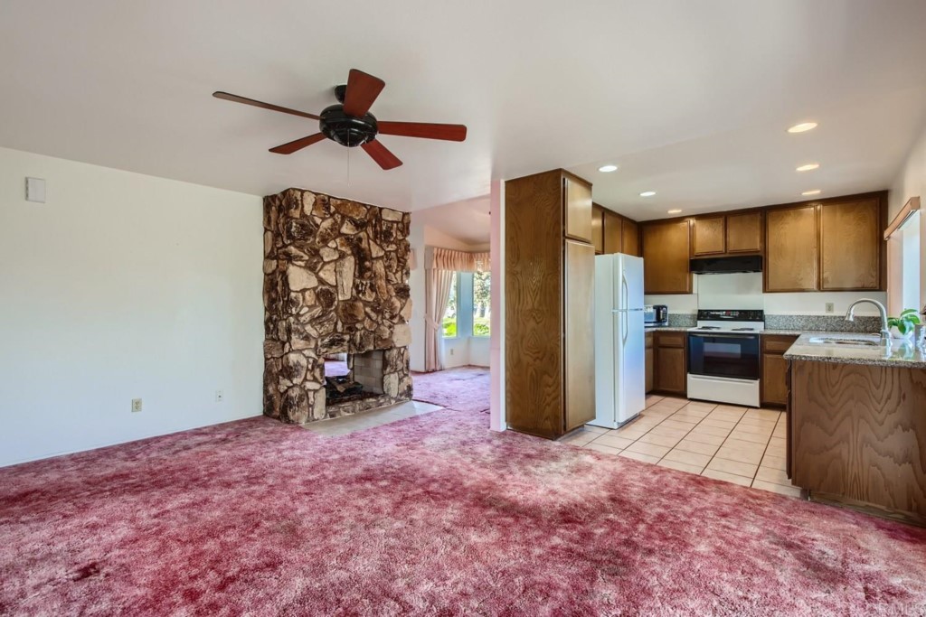 404 Compass Road Oceanside, CA 92054 - Photo 10 of 26 a view of a kitchen with a refrigerator and microwave