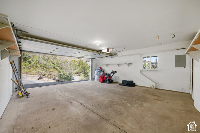 380 Luzern Road Midway, UT 84049 - Photo 17 of 41 Spacious garage featuring a concrete floor, built-in shelving, a window, and an automatic garage door opener