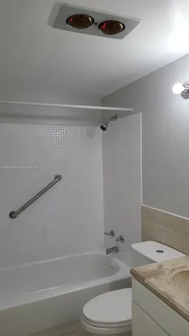 a bathroom with a sink a toilet and a bathtub