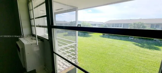 a view of an empty room and a window