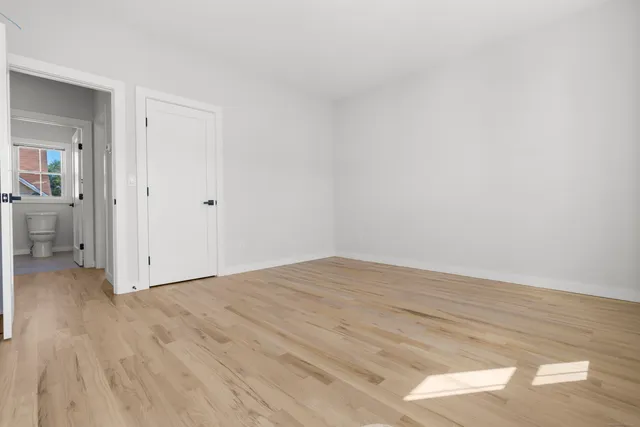 a view of an empty room and wooden floor